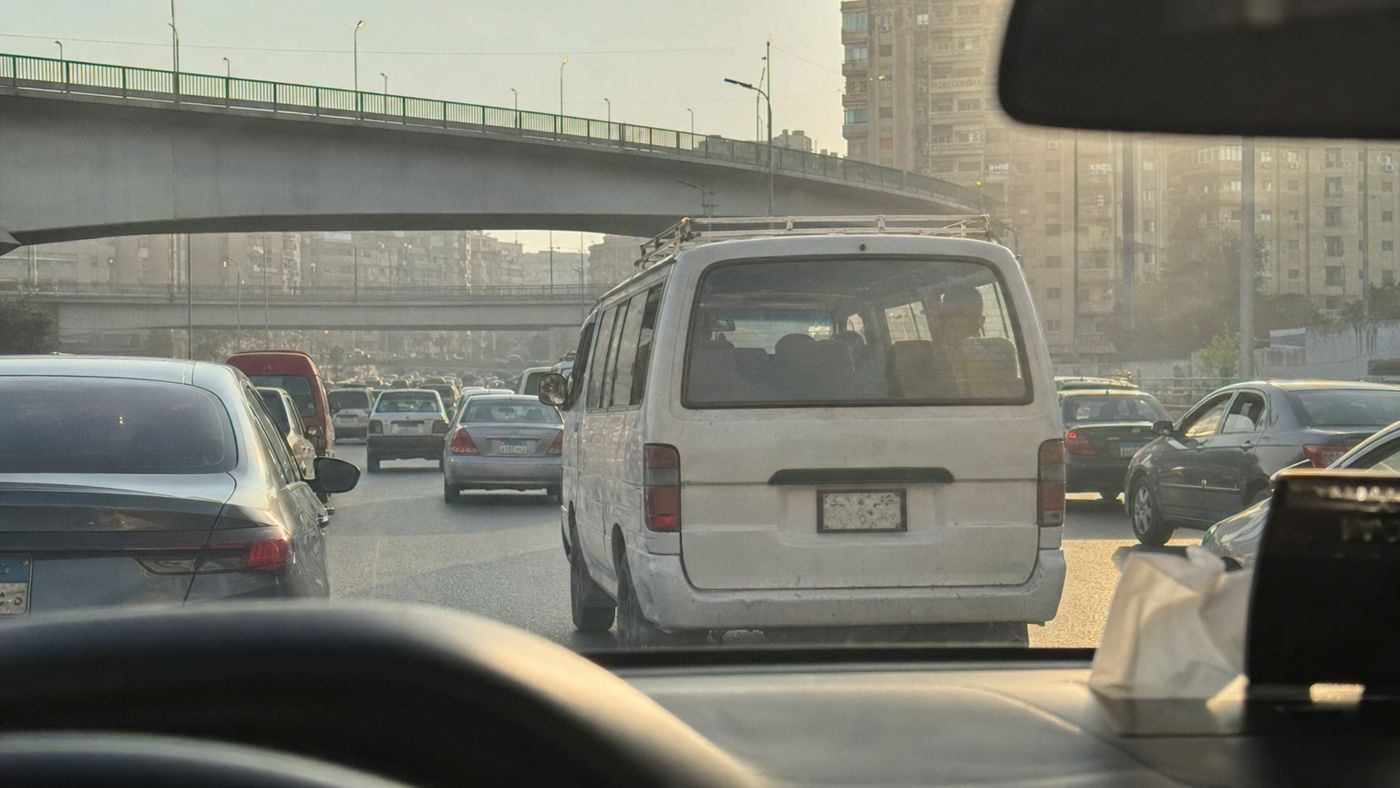 Minibus with travelers on a multi-lane road in Cairo in morning traffic