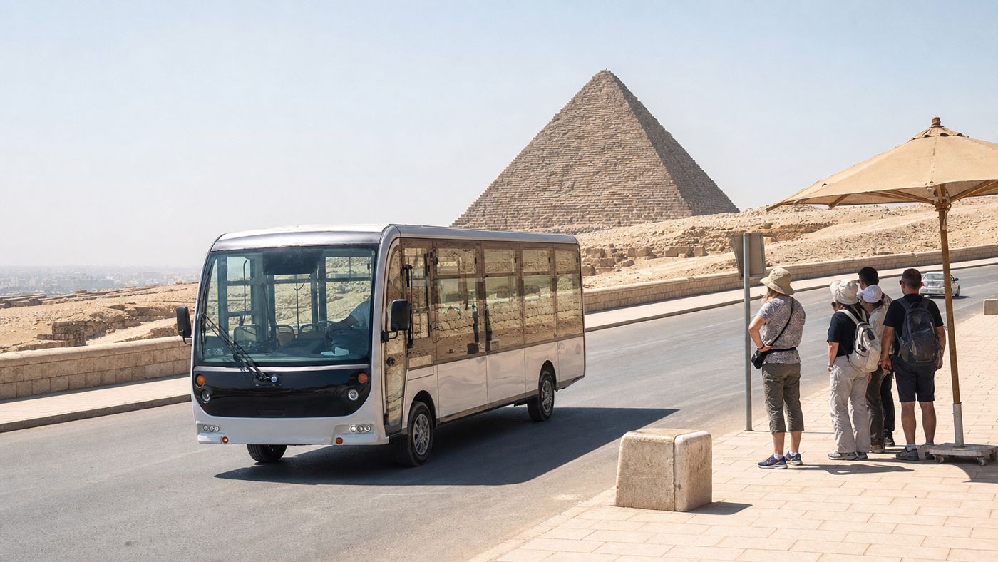 Electric shuttle bus in front of a pyramid on the redesigned Giza Plateau