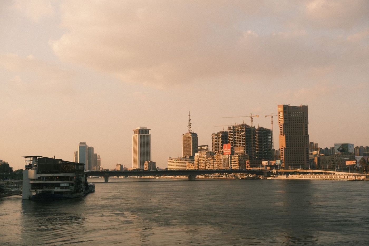 Skyline of Cairo on the Nile in late afternoon light, high-rises and a bridge