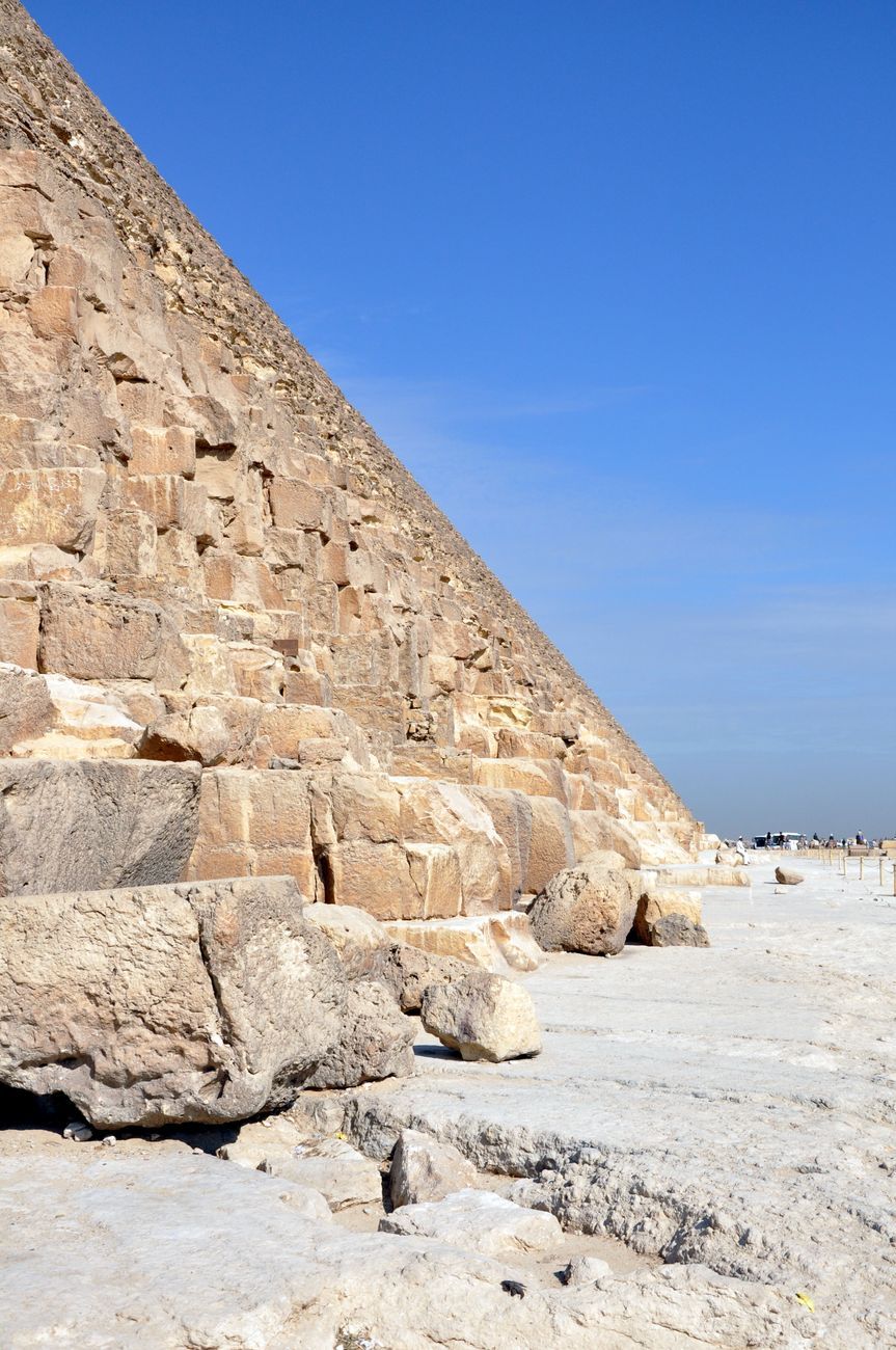 The base edge of a pyramid with a survey marker in the foreground
