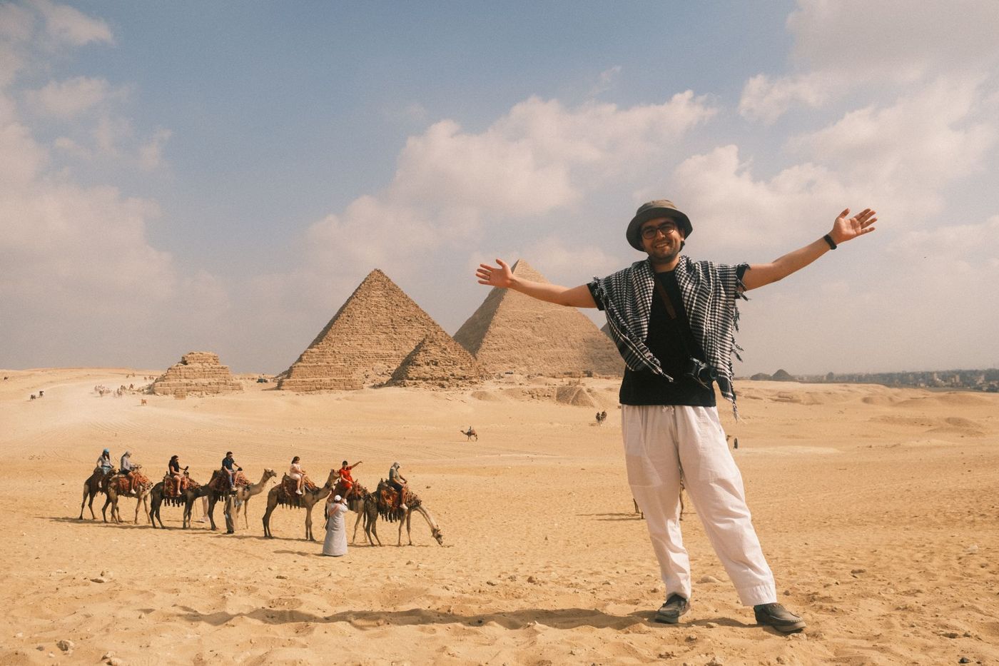 Visitor photographs the pyramids early in the morning with a smartphone