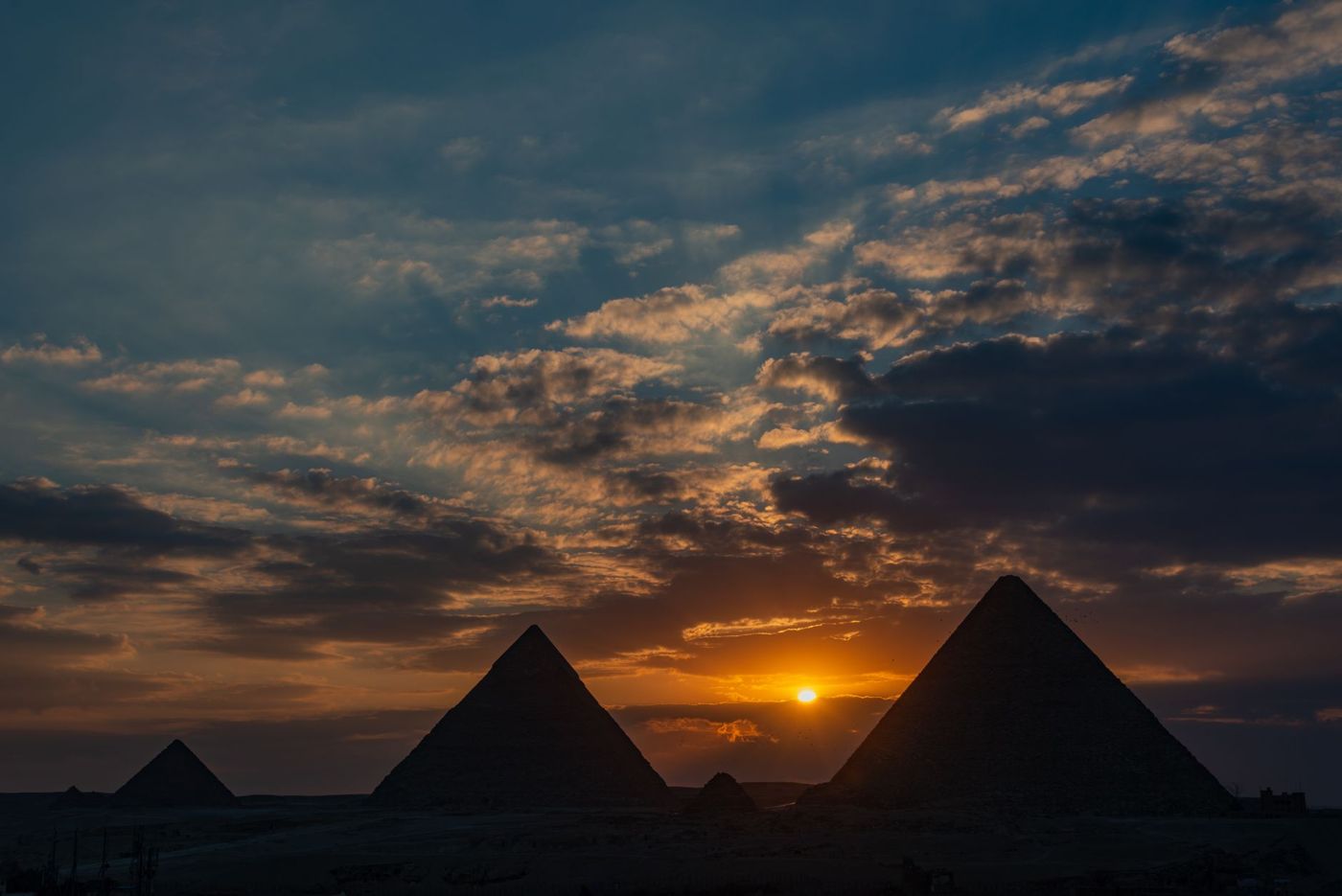 The three pyramids of Giza staggered in the evening light
