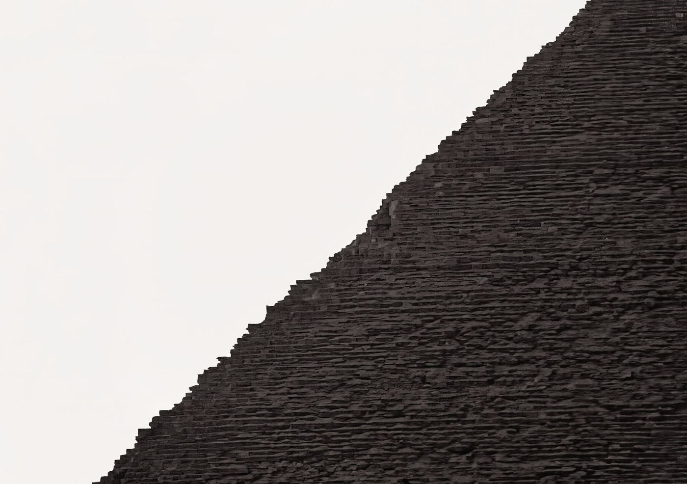 Rough limestone blocks of a pyramid flank up close