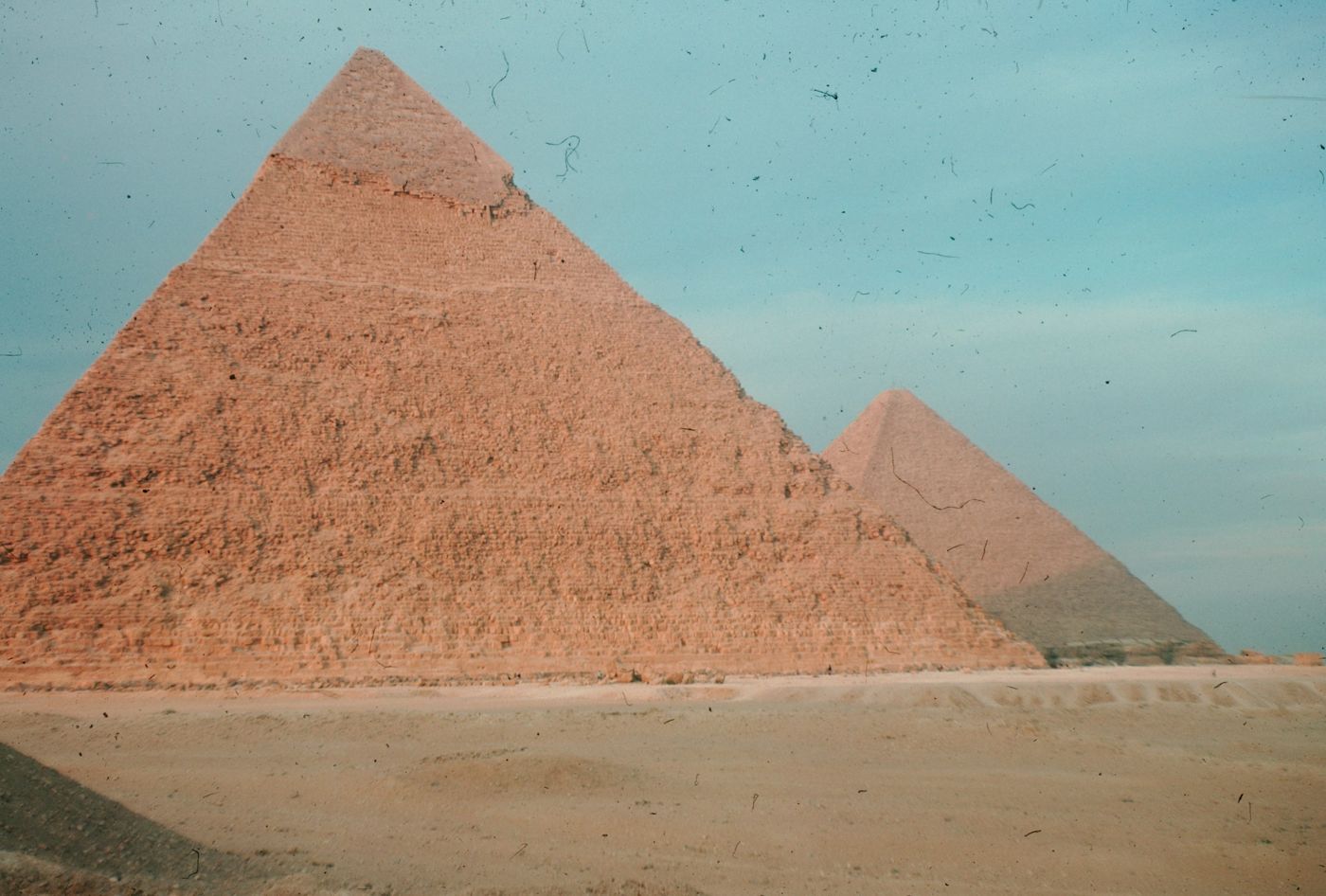 One of the queen's pyramids east of the Great Pyramid, with the large structure in the background