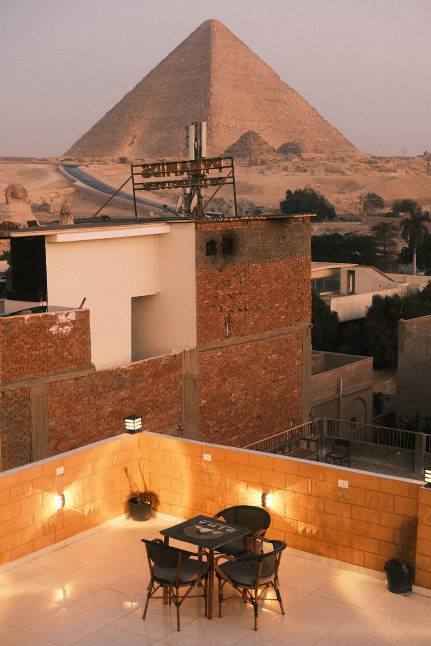 View from a rooftop terrace over the forecourt to the Sphinx and a pyramid behind it