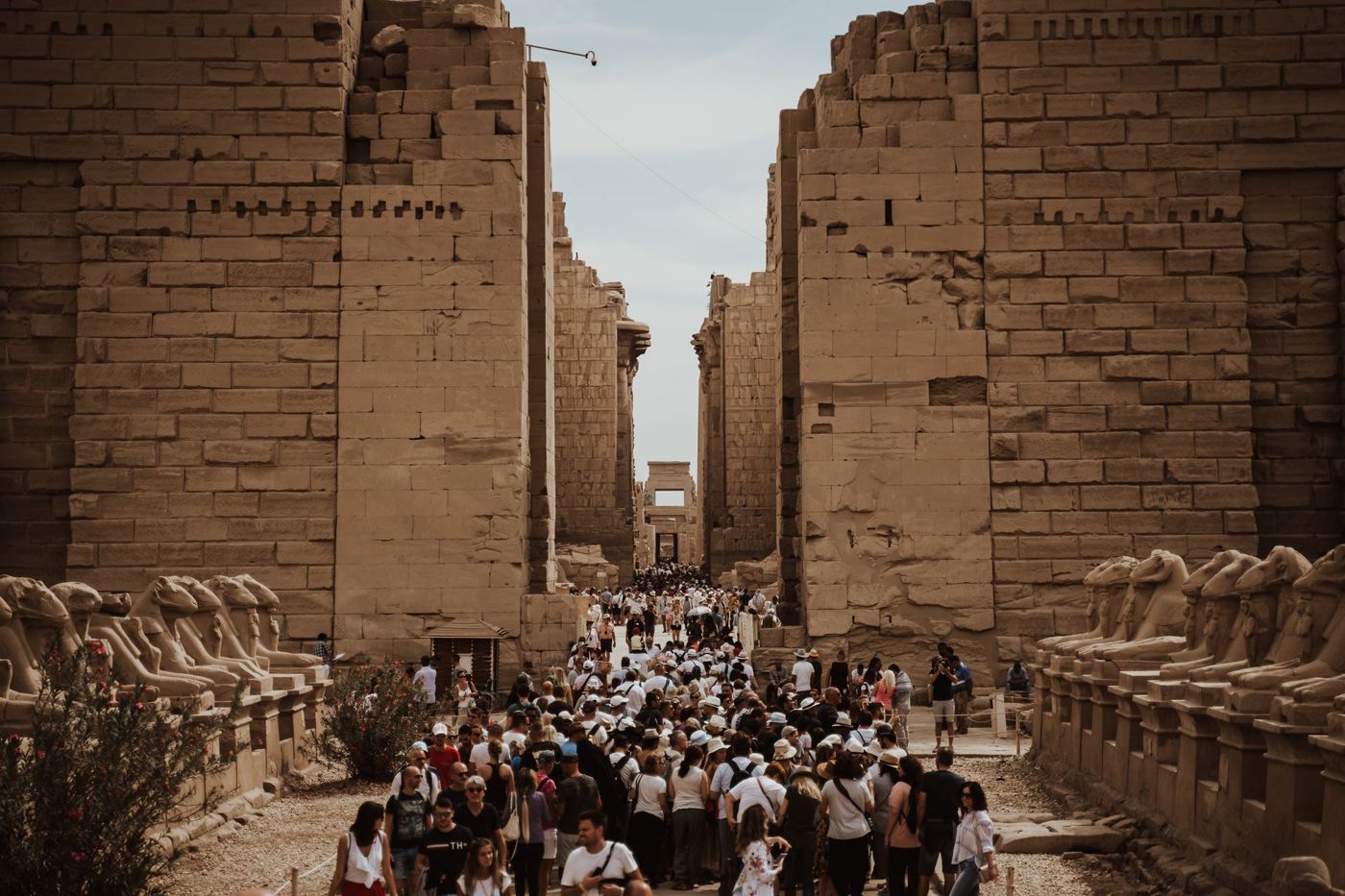 Dense crowds between the ram-headed sphinxes at the first pylon of Karnak